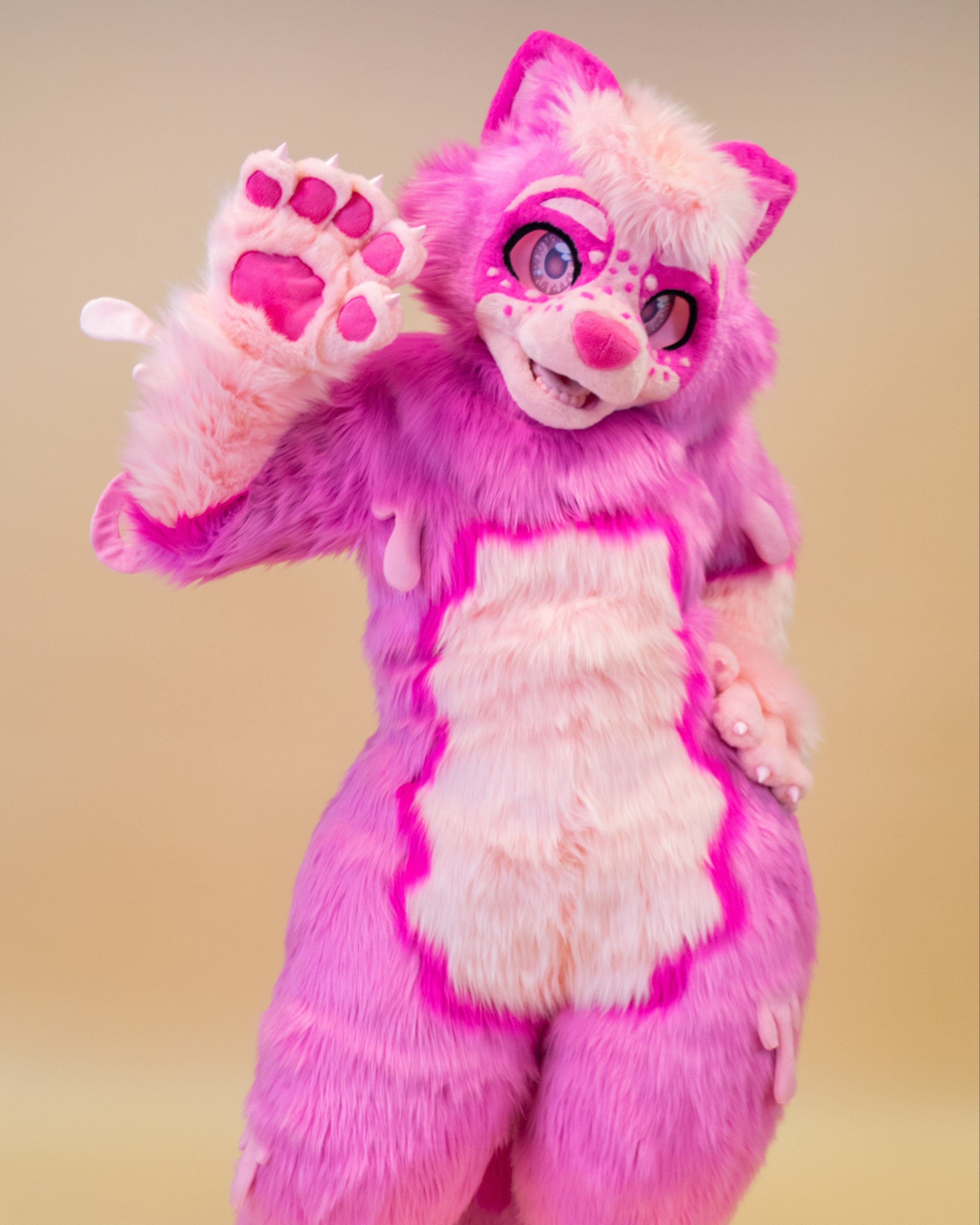 Pink and white furry costume on a beige background